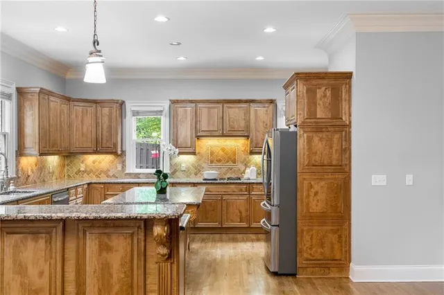 a bathroom with a granite countertop sink and a large mirror
