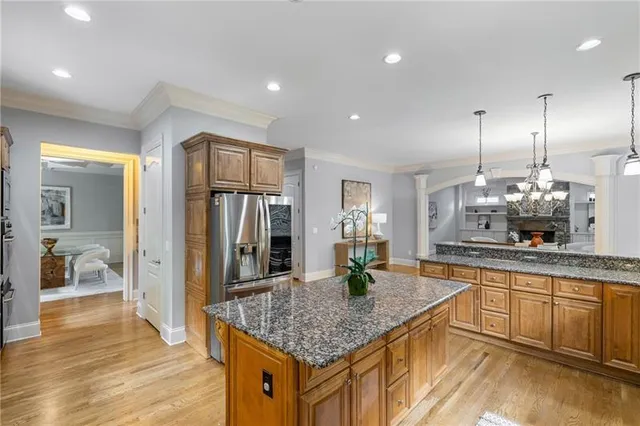 a living room with furniture a fireplace and a chandelier