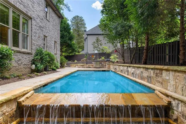 a view of swimming pool with a patio