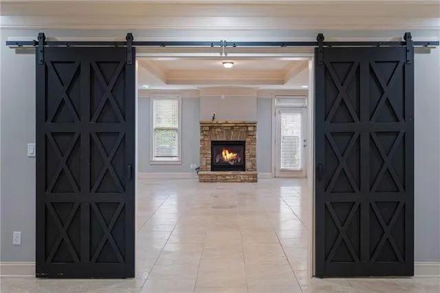 a view of an empty room with a fireplace and a window