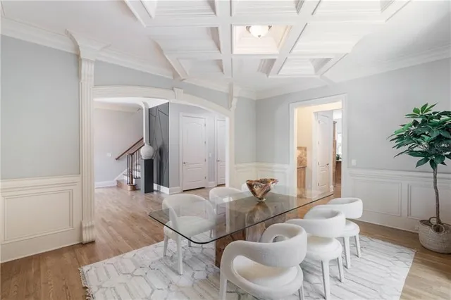 a kitchen with stainless steel appliances granite countertop wooden floors and white cabinets
