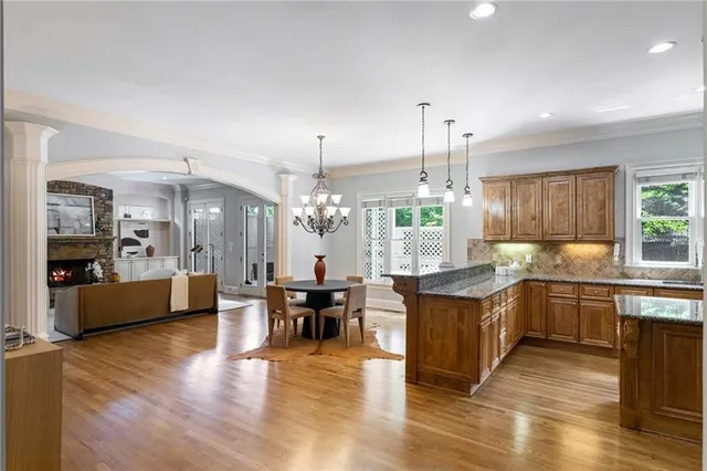 a kitchen with granite countertop a sink a counter space stainless steel appliances and cabinets