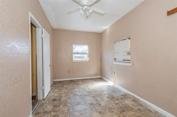 a hallway with a sink and cabinets