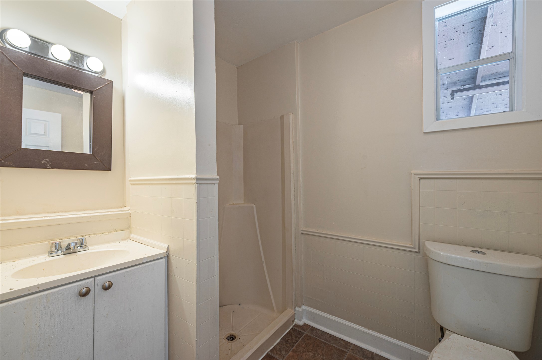 307 York Street, Unit 4 Houston, TX 77003 - Photo 18 of 38 a bathroom with a sink and mirror with toilet