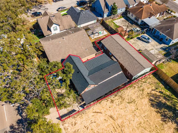 an aerial view of a house with a yard