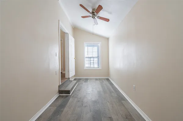 a view of a kitchen with refrigerator and windows