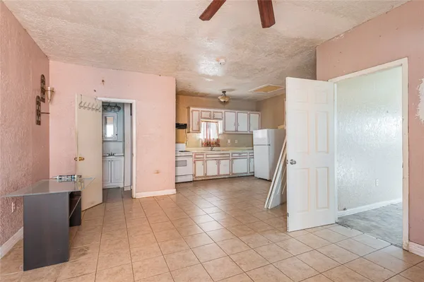 a kitchen with a refrigerator sink and cabinets