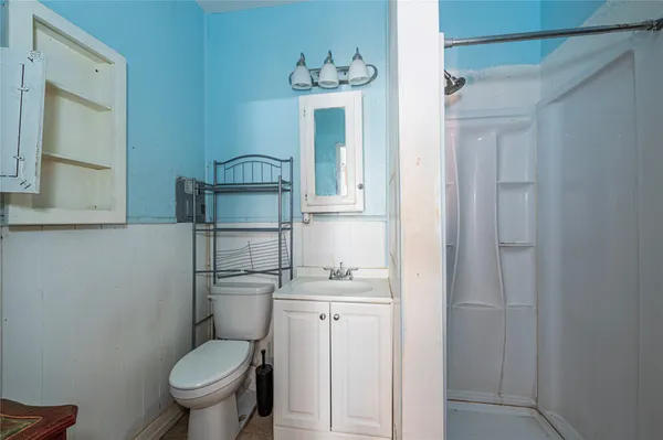 an empty room with fan and windows