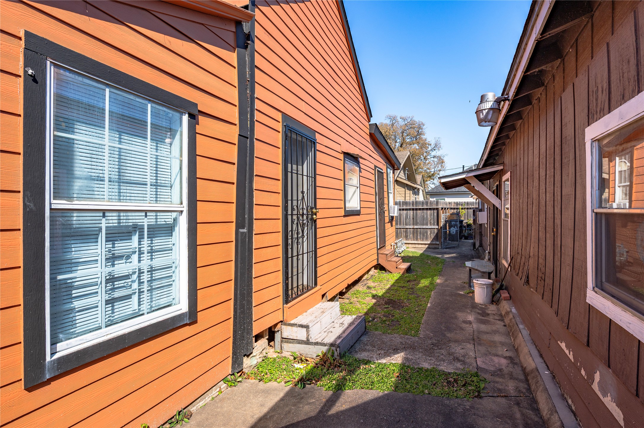 307 York Street, Unit 4 Houston, TX 77003 - Photo 6 of 38 a view of a pathway of a house with backyard and wooden fence