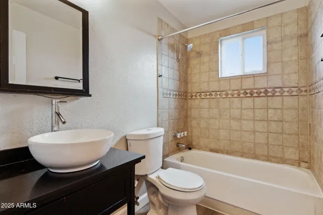 a bathroom with a sink a toilet and bathtub