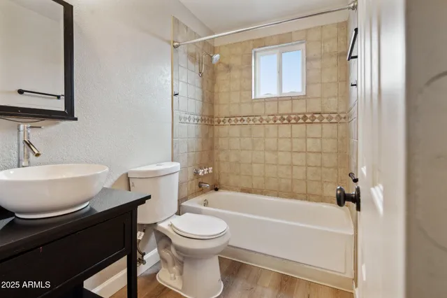 a bathroom with a toilet a sink and bathtub