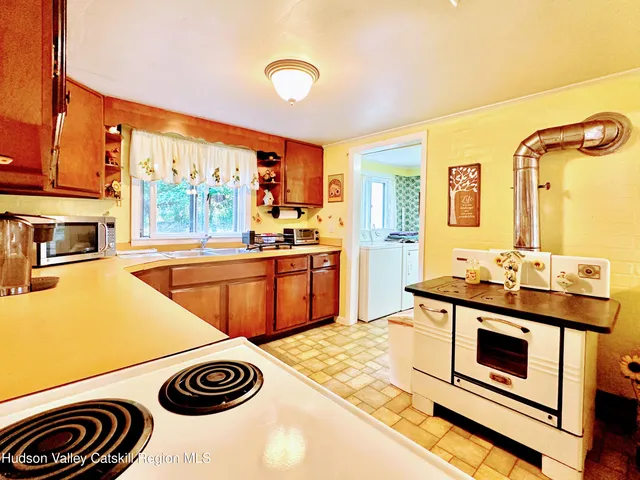 a kitchen with stainless steel appliances granite countertop a sink and a cabinets