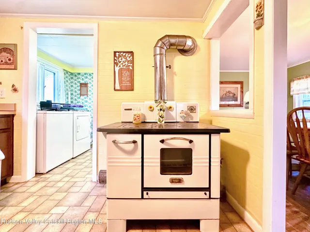 a view of a dining room with furniture a chandelier and wooden floor
