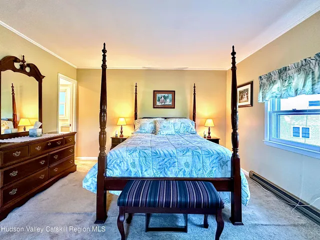 a bedroom with two beds and a window