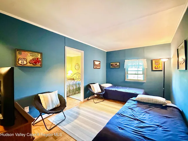 a bedroom with furniture and a large window