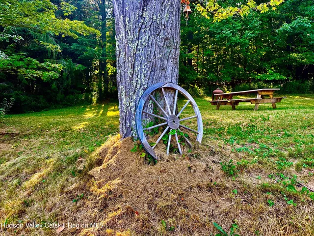 a wooden bench sitting in the middle of a garden