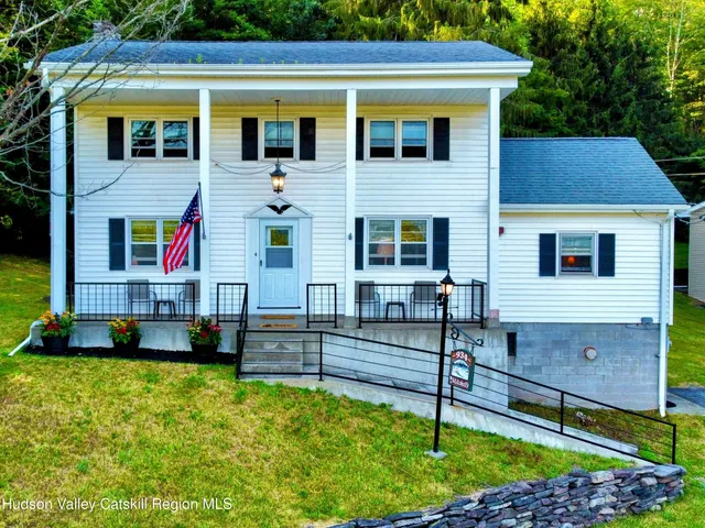 a view of a lush green forest with mountains in the background