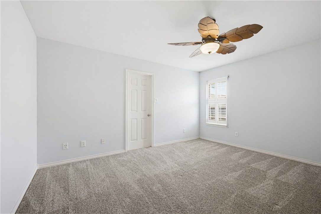 7251 Prairie Drive, Unit 6 Corpus Christi, TX 78413 - Photo 20 of 28 an empty room with windows and fan