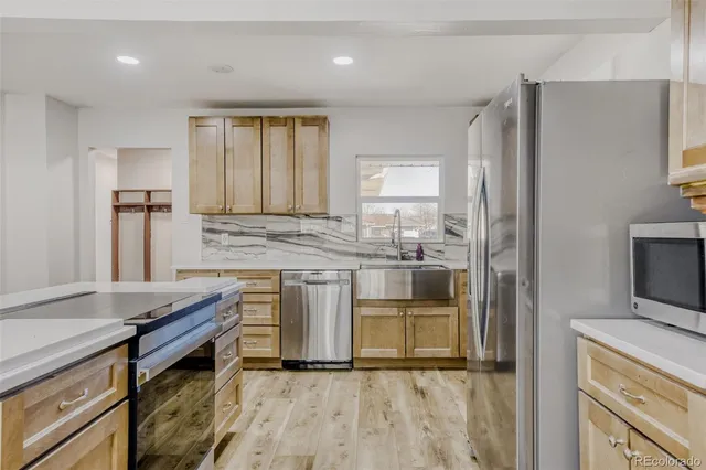 a kitchen with a stove a sink and a refrigerator