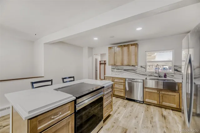 a kitchen with a sink stove and cabinets