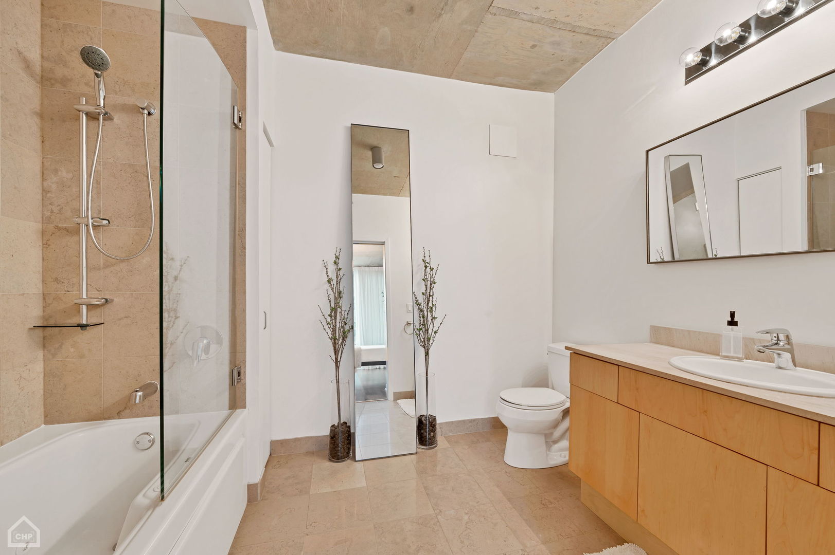 611 South Wells Street, Unit 904 Chicago, IL 60607 - Photo 12 of 17 a bathroom with a sink a toilet and shower