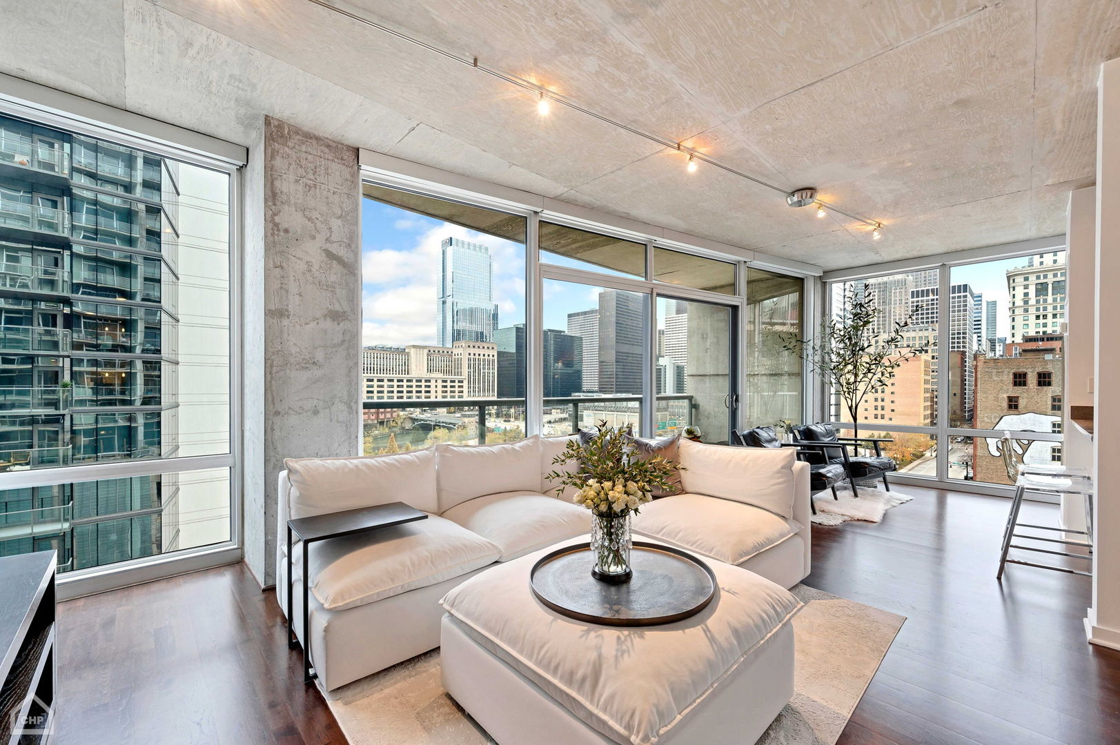 611 South Wells Street, Unit 904 Chicago, IL 60607 - Photo 2 of 17 a living room with furniture and a large window