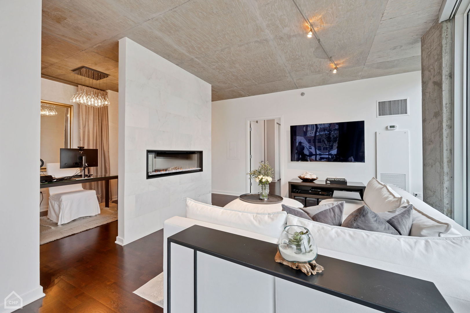 611 South Wells Street, Unit 904 Chicago, IL 60607 - Photo 7 of 17 a living room with furniture and a flat screen tv