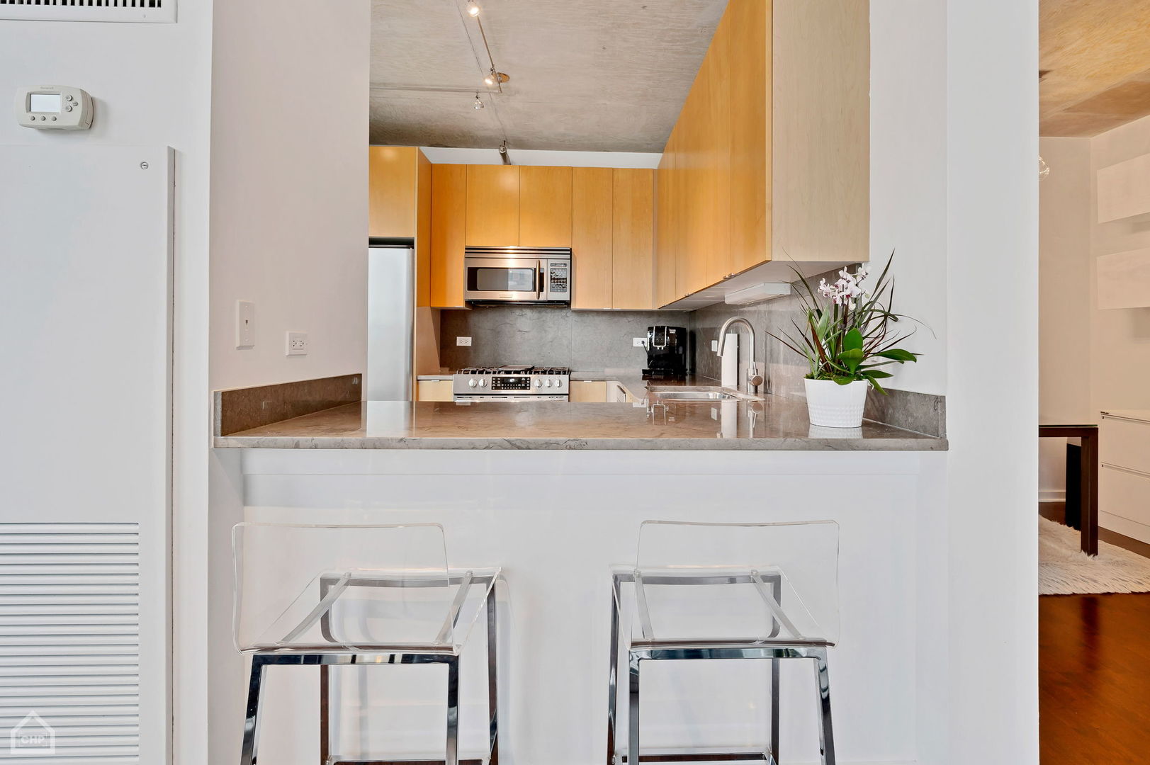 611 South Wells Street, Unit 904 Chicago, IL 60607 - Photo 8 of 17 a kitchen with stainless steel appliances a sink a window and cabinets