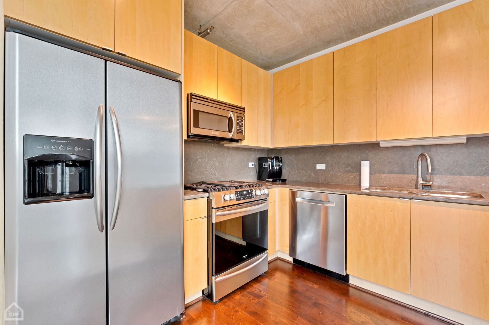 611 South Wells Street, Unit 904 Chicago, IL 60607 - Photo 9 of 17 a kitchen with stainless steel appliances a stove a sink and a refrigerator
