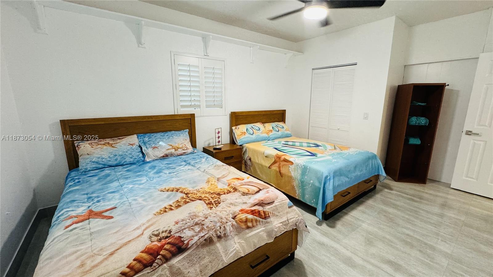 443 4th Road Key Largo, FL 33037 - Photo 11 of 17 a bedroom with two beds and a chandelier