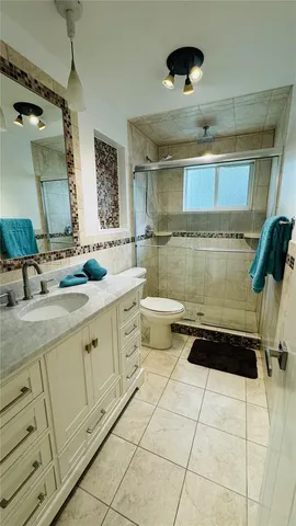 a bathroom with a double vanity sink a toilet and a mirror