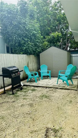 a backyard of a house with table and chairs