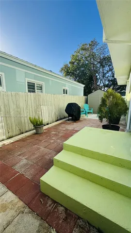 a view of a two chairs in the yard