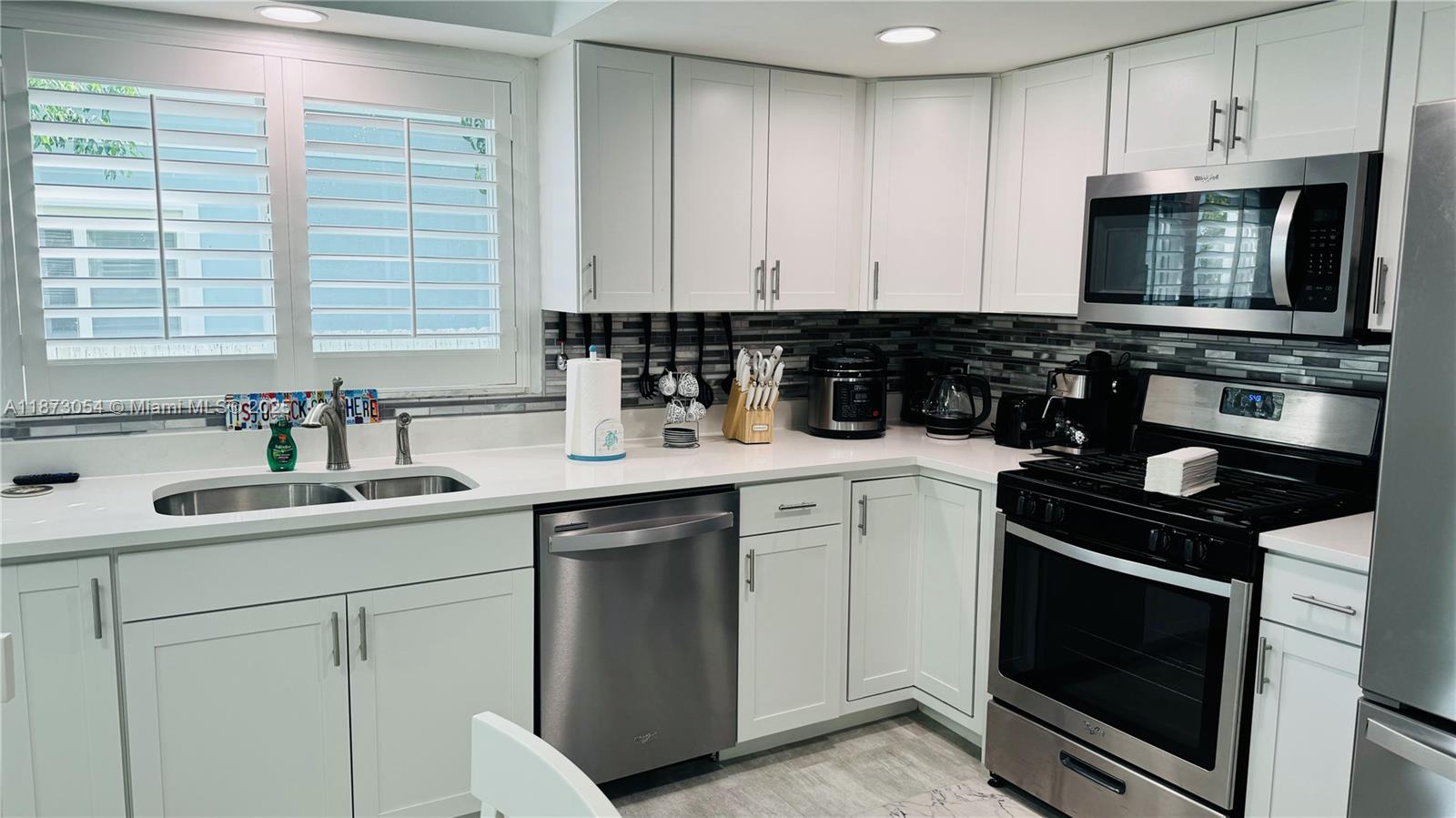 443 4th Road Key Largo, FL 33037 - Photo 4 of 17 a kitchen with a sink stove and microwave