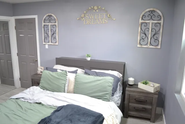 a room with gym equipment and wooden floor