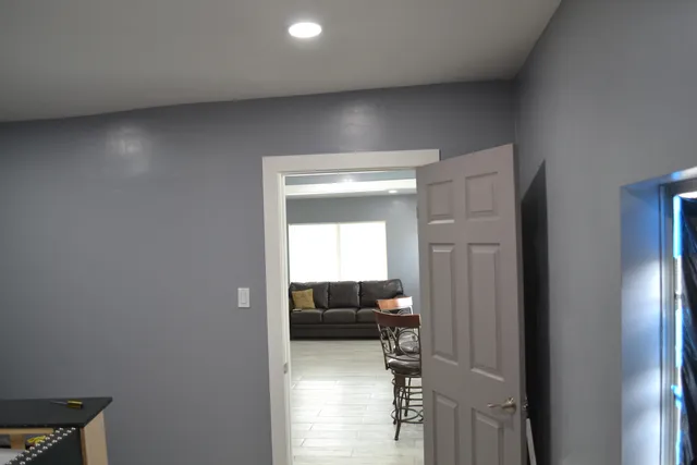a view of a hallway with wooden floor and staircase