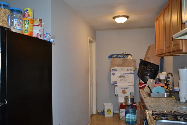 a bathroom with a granite countertop toilet and a sink