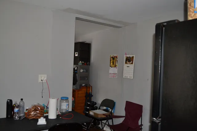 a living room with furniture cabinets and a window