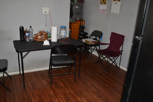 a living room with furniture closet and a potted plant