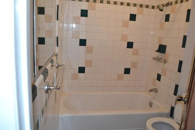 an aerial view of a house with swimming pool and a yard