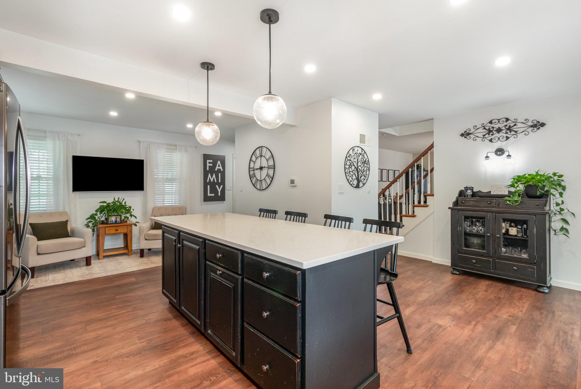 212 Weaver Drive Lititz, PA 17543 - Photo 11 of 44 a large kitchen with a counter space a sink appliances and living room view
