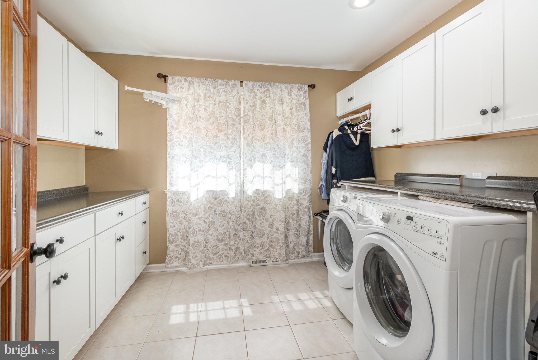 212 Weaver Drive Lititz, PA 17543 - Photo 15 of 44 a utility room with cabinets washer and dryer