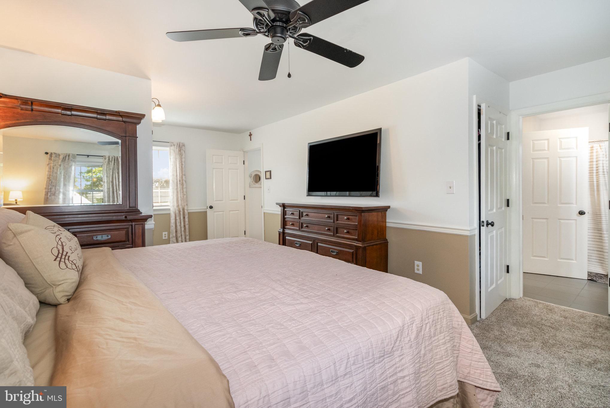 212 Weaver Drive Lititz, PA 17543 - Photo 18 of 44 a bedroom with a bed and a flat screen tv