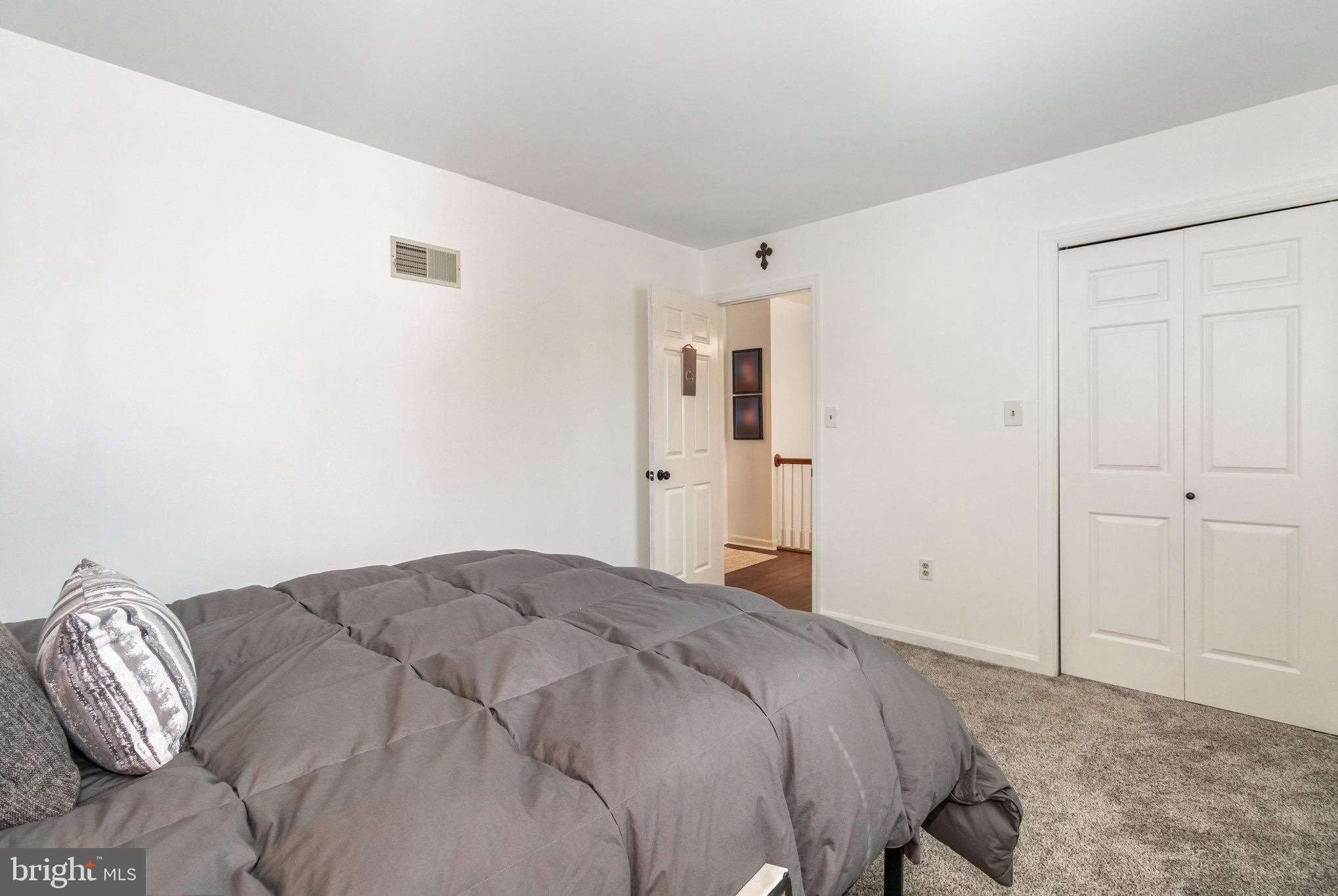 212 Weaver Drive Lititz, PA 17543 - Photo 22 of 44 a bedroom with a bed and a painting on the wall