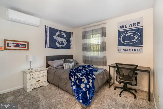 a bedroom with furniture and a window