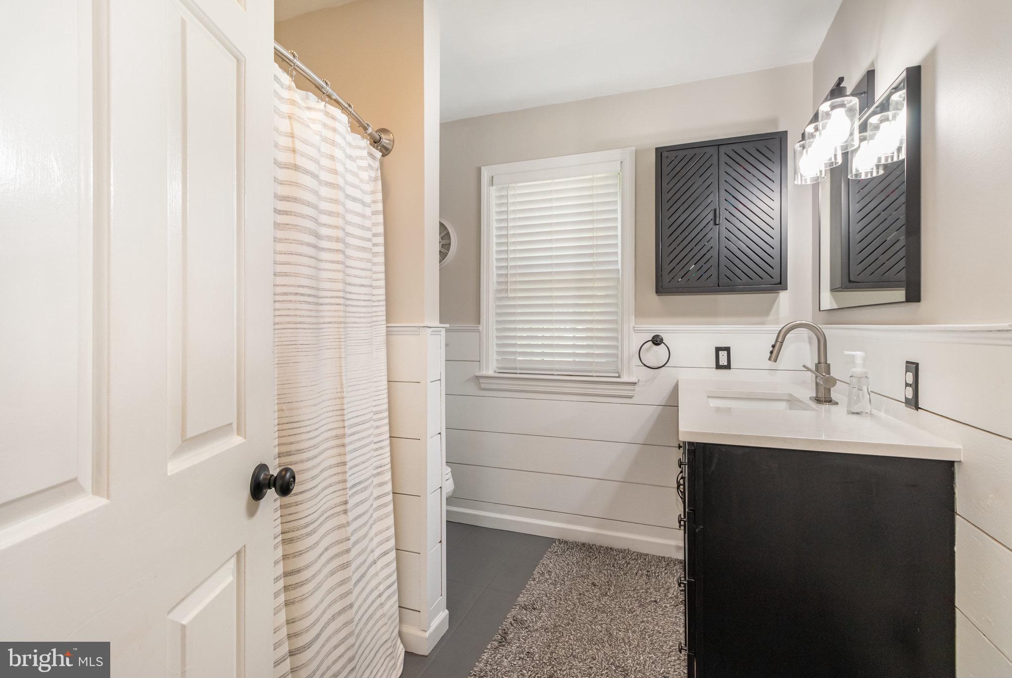 212 Weaver Drive Lititz, PA 17543 - Photo 24 of 44 a bathroom with a double vanity sink a mirror and a shower