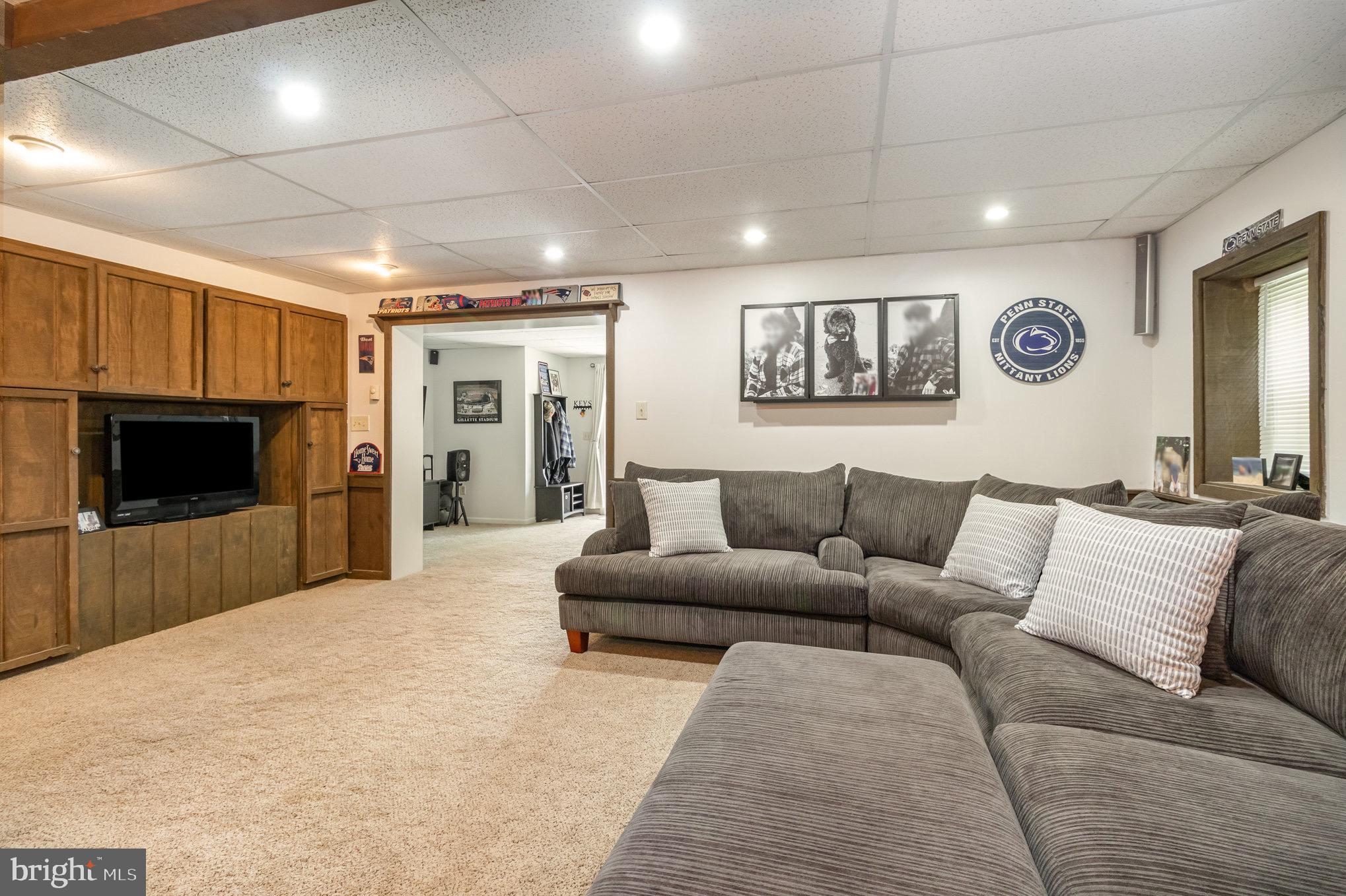 212 Weaver Drive Lititz, PA 17543 - Photo 27 of 44 a living room with furniture and a flat screen tv