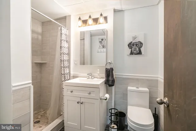 a bathroom with a toilet sink and mirror