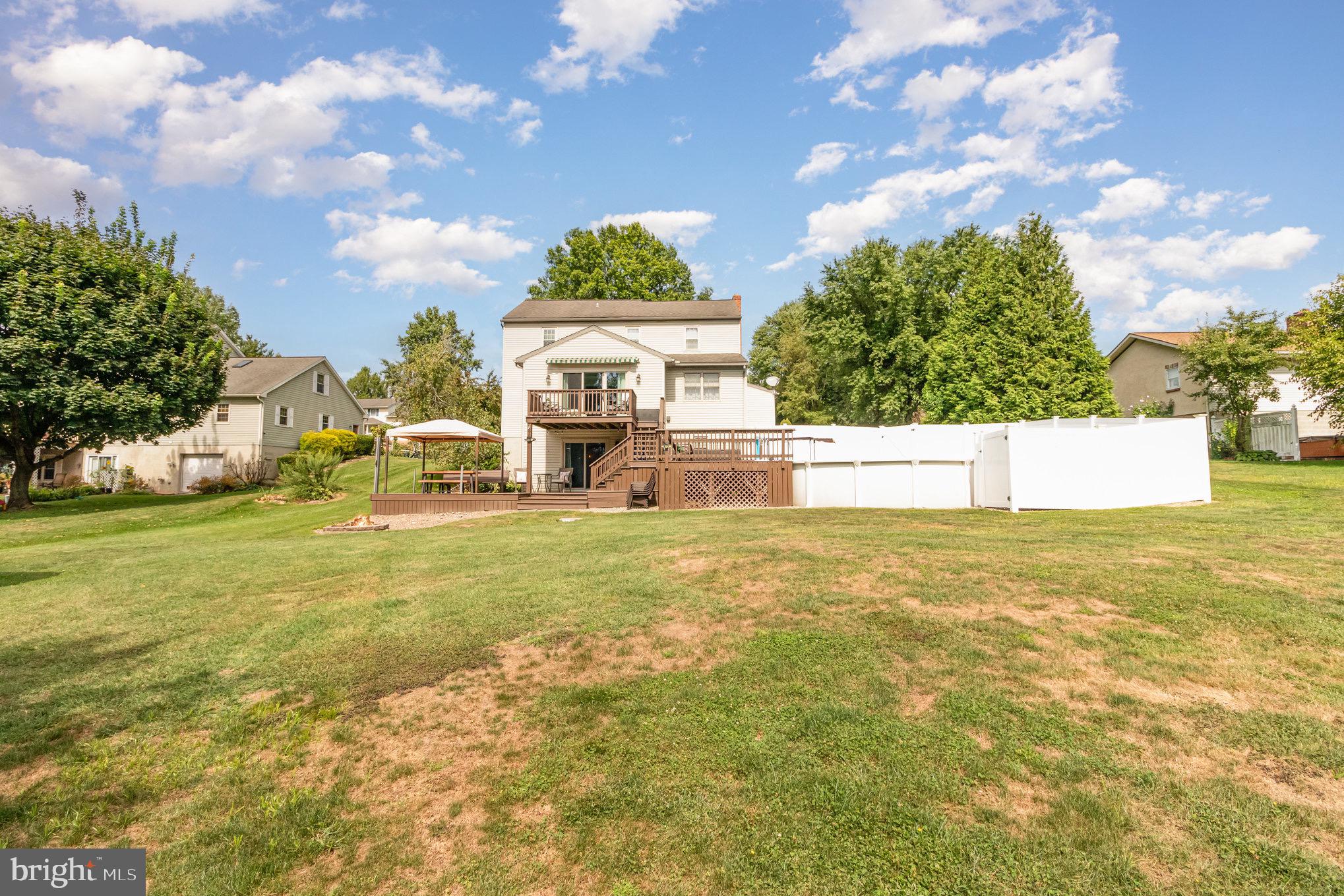 212 Weaver Drive Lititz, PA 17543 - Photo 37 of 44 a house view with swimming pool and trees in the background