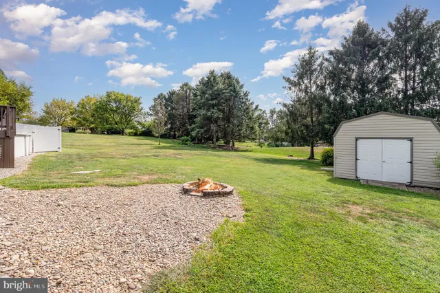 a backyard of a house with a yard and outdoor seating